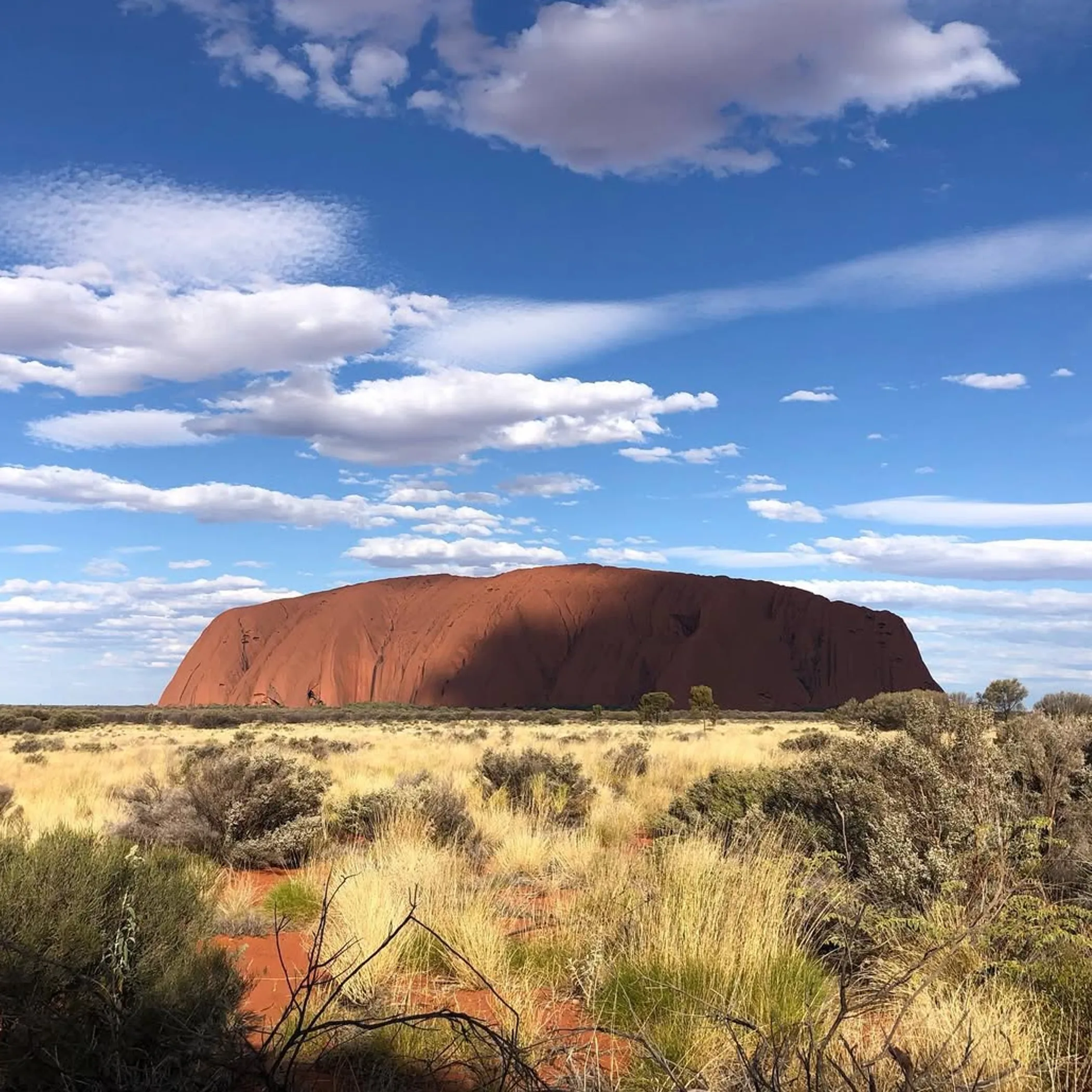 uluru rock with surrounding landscape
